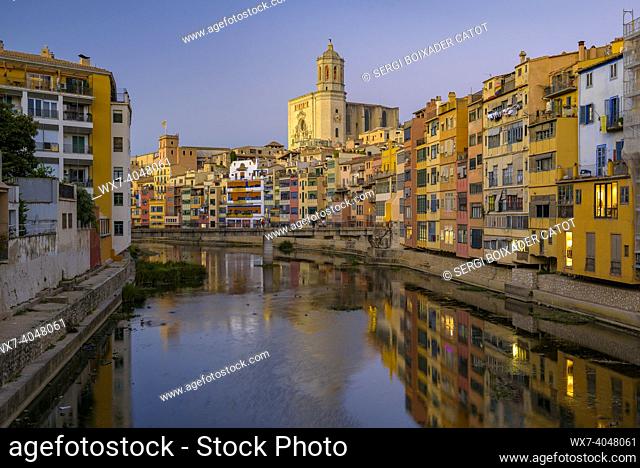 Girona Cathedral and houses next to the Onyar river at twilight (Girona, Catalonia, Spain)