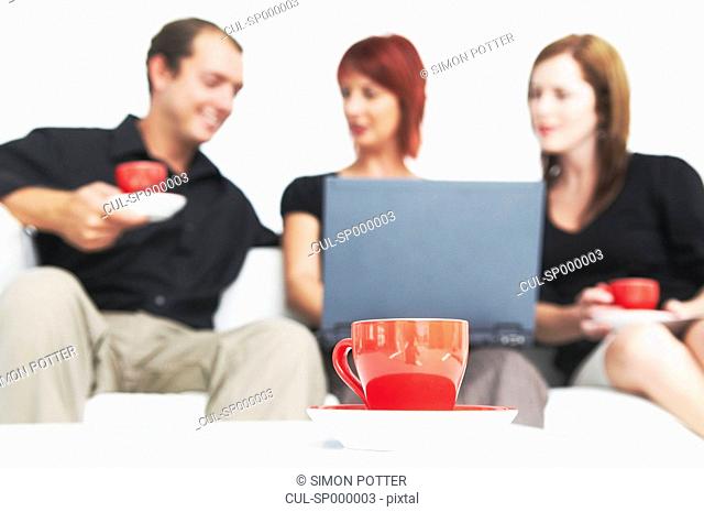 Three people talking with hot drink