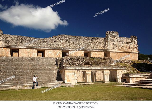Tourist walking in Uxmal Ruins near the Quadrangle Of The Nuns, Yucatan Province, Mexico, Central America