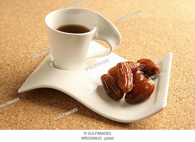 Cups of coffee and dates
