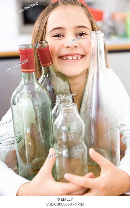 Girl recycling empty bottles