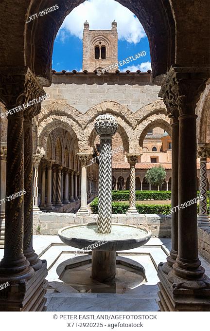 Decorated columns and fountain in The Chiostro dei Benedettini, cloisters, in the cathedral complex at Monreale near Palermo, Sicily, Italy