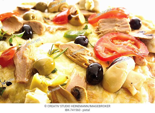 Pizza with tuna, olives, mushrooms and tomatoes