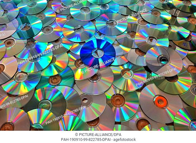 19 August 2019, Berlin: CD discs recorded with music or data are lying on the floor before disposal. Less and less data is stored on physical removable media
