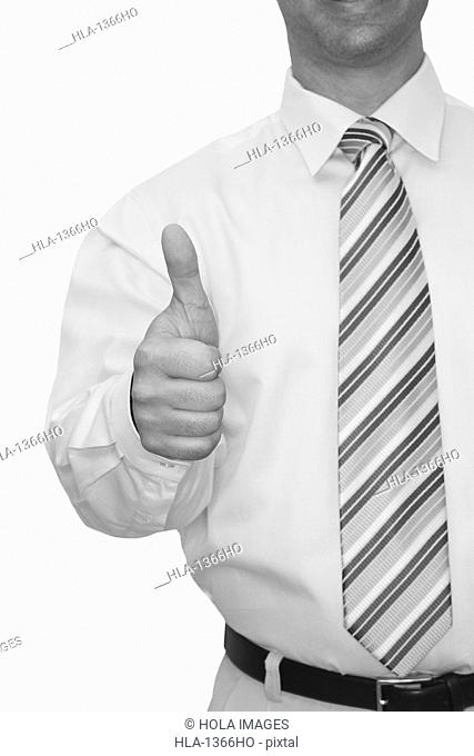 Mid section view of a man making a thumbs up sign