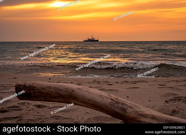 Evening at the beach in Ahrenshoop, Mecklenburg-Western Pomerania, Germany - with a ship in the background