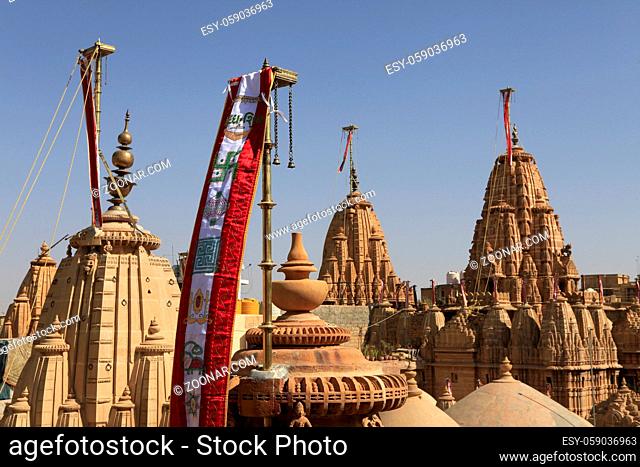 Flags and detail reliefs on rooftops of Jain temple in Jaisalmer, Rajasthan