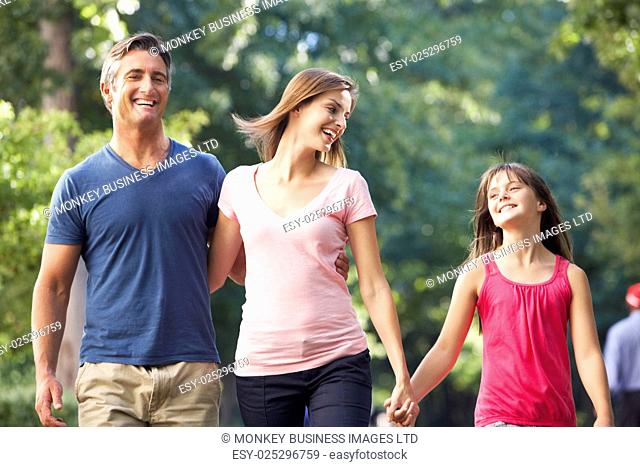 Family Walking Through Summer Park