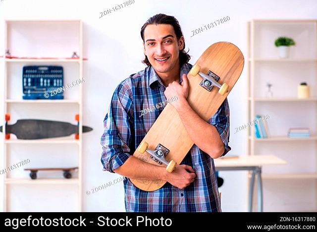 Man repairing skateboard at workshop