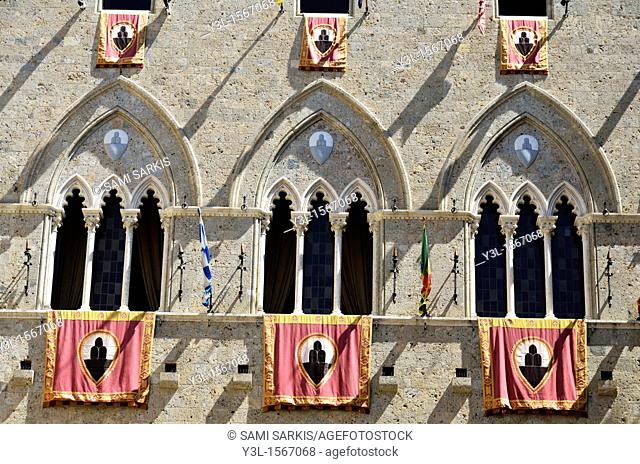 Palazzo Salimbeni with flags during the Palio di Siena, Tuscany, Italy