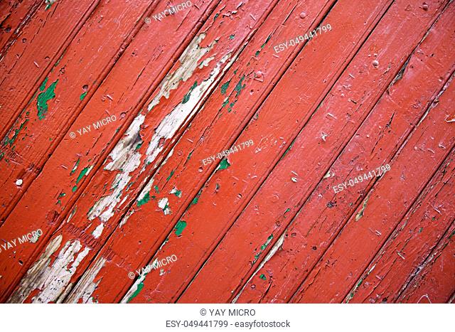 Red wood background with texture, detail of an old painted wood in the city, abandonment and blight
