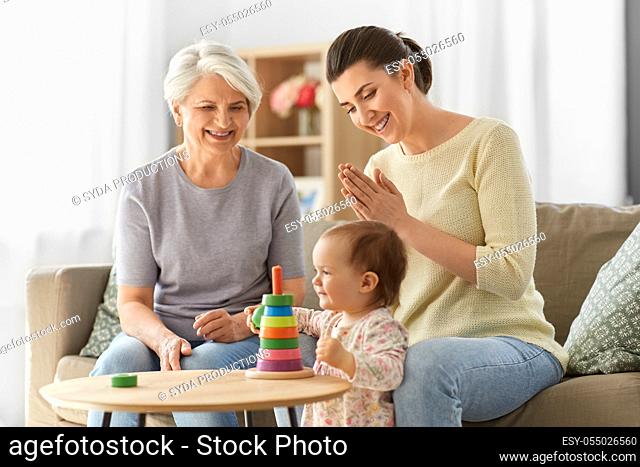 mother, baby daughter and granny playing at home