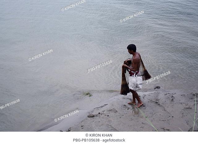 A man catches fishes at the Padma river Pabna, Bangladesh June 2010