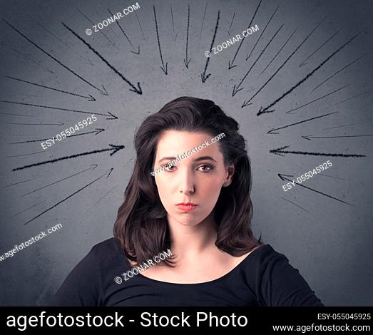 A teenage student girl under pressure while making happy face expressions illustrated with black arrows pointing at her head on the wall blackground concept