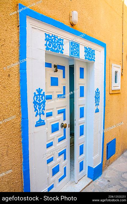 Oriental white blue door with ornament in Hammamet Tunisia