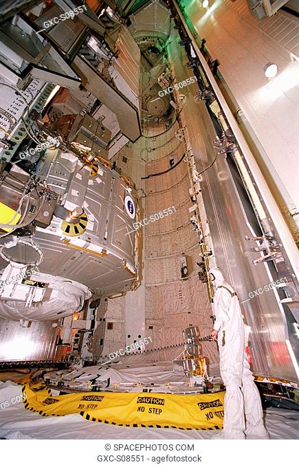 06/26/2001 -- The Joint Airlock Module, sporting a NASA logo, is moved toward the payload bay of Space Shuttle Atlantis for mission STS-104