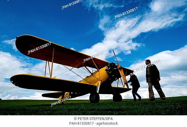 Pilot Alexander Stendel (R) stands in front of his historical Boeing Stearman from 1943 on the Ithwiesen airfield in Capellenhagen,  Germany, 18 June 2016