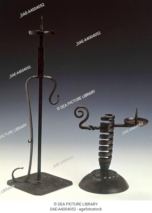 artefact A: height adjustable candlestick (shokudai), 19th century, cast iron, height 39.5 cm. artefact B: Height adjustable spiral candlestick (shokudai)