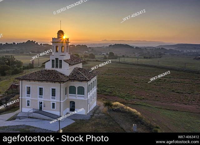Torre LluviÃ  de Manresa, surrounded by vineyards of the DO Pla de Bages, in an aerial view of a summer sunrise (Barcelona province, Catalonia, Spain)