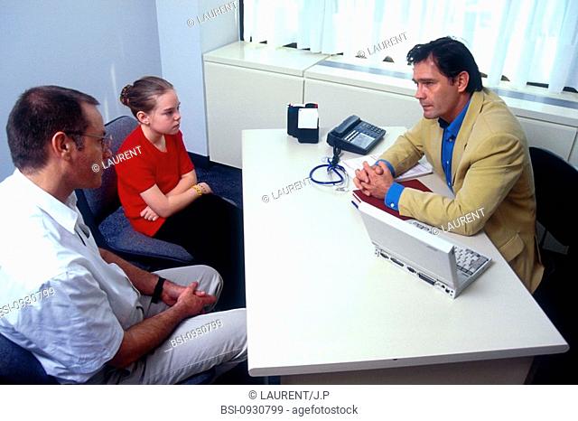 ANOREXIA, CHILD<BR>Models.<BR>Father and daughter consulting with doctor for problem of anorexia