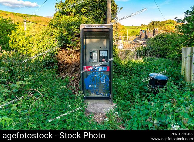 Osmington Mills, Jurassic Coast, Dorset, UK - April 25, 2017: An old telephone booth
