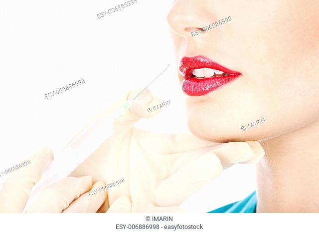 Syringe in hands to put silicone in lips, isolated on white