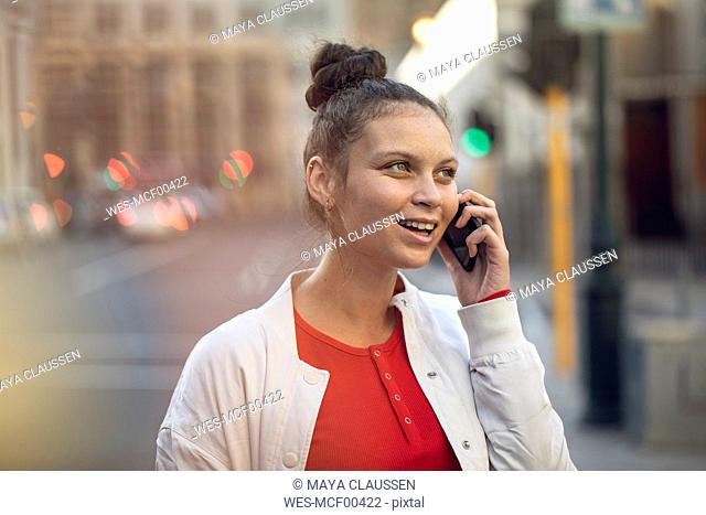 Young woman on the phone in the city
