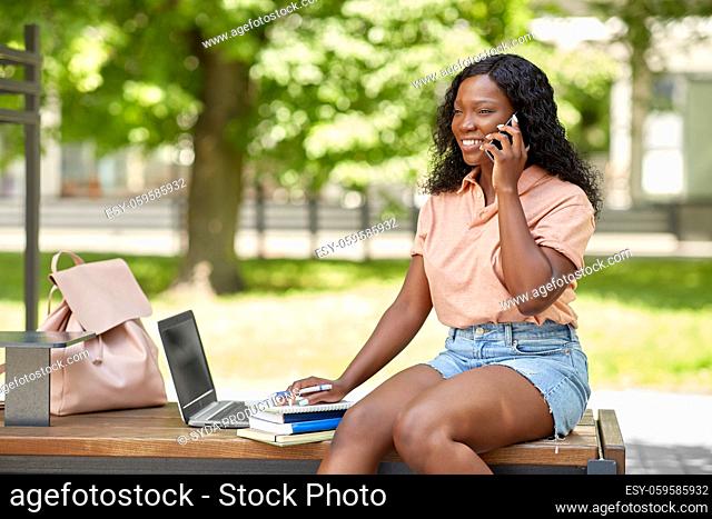 african student girl calling on smartphone in city