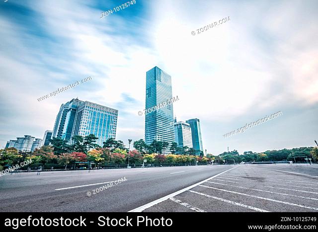modern office buildings in seoul in cloud sky from empty road