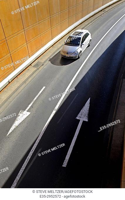 A car enters a street underpass in the city of Béziers, France