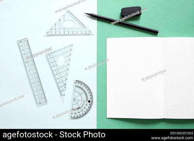 elevated view geometric equipment notebook pencil eraser dual colorful background