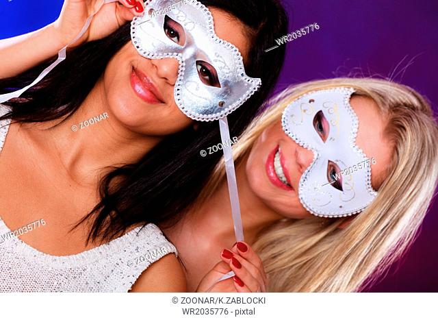 Two women face with carnival venetian masks