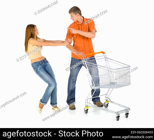 Young couple with trolley. Girl is holding boy and begging for something. Isolated on white in studio. Whole body