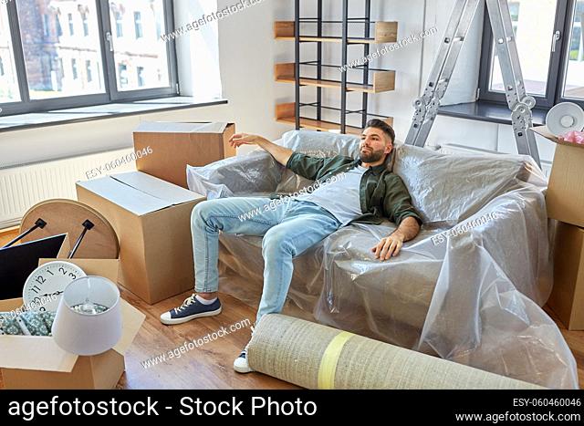 tired man with boxes moving to new home
