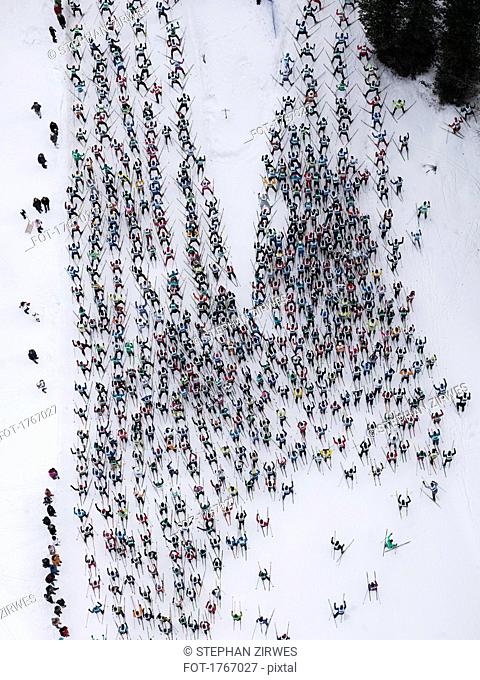 Aerial view large group of skiers on snowy slope, St. Moritz, Switzerland