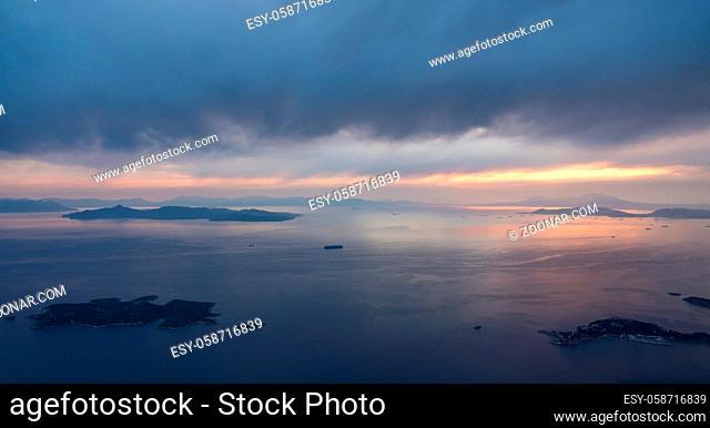 View of coastline and islands near Athens airport as plane descends at sunset