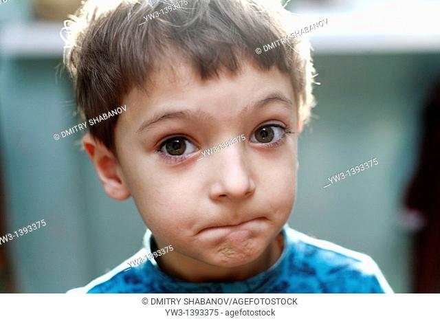 Portrait of a cute little boy grimasing