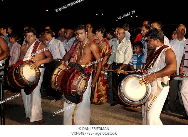 CANADA, BRAMPTON, 08.08.2015, Tamil Hindu musicians playing the Thavil (a traditional drum) lead the chariot procession during the Aadivel Festival (Aadi Vel...