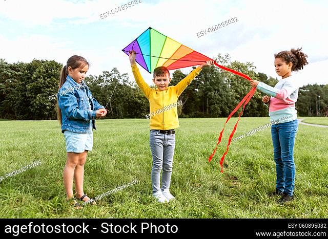 happy kids with kite playing at park