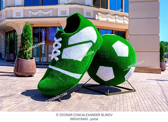 Samara, Russia - June 23, 2018: Art installation in the form of a soccer boot and ball near the Lotte Hotel Samara in sunny day