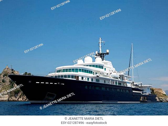 Gigantic big and large luxury yacht with sail boat and helicopter landing place on bord