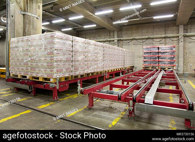 Warehouse, and distribution centre for goods, platforms and pallets, lifting equipment, and racking. Shrinkwrapped cartons