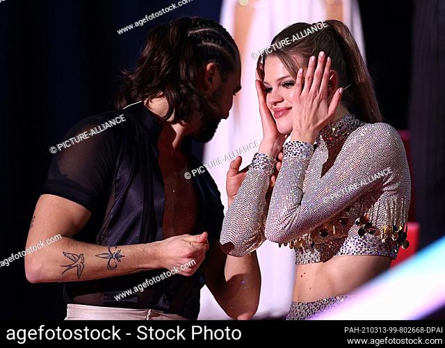 13 March 2021, North Rhine-Westphalia, Cologne: Kim Riekenberg, model, and Pasha Zvychaynyy, professional dancer, react to the jury's decision that they have to...