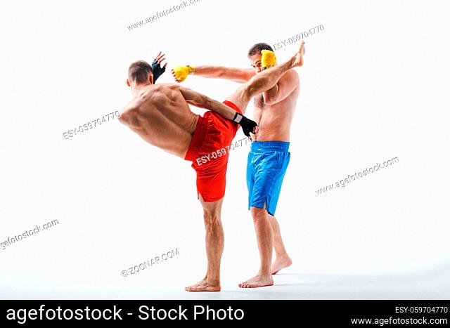 Two men boxers fighting muay thai boxing white background