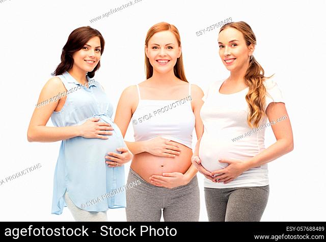 happy pregnant women touching their big bellies