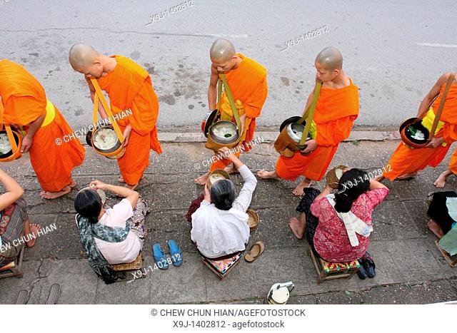 Morning round of buddhist monks begging for alms or Tak Bat, Luang Prabang, UNESCO World Heritage Site, Laos