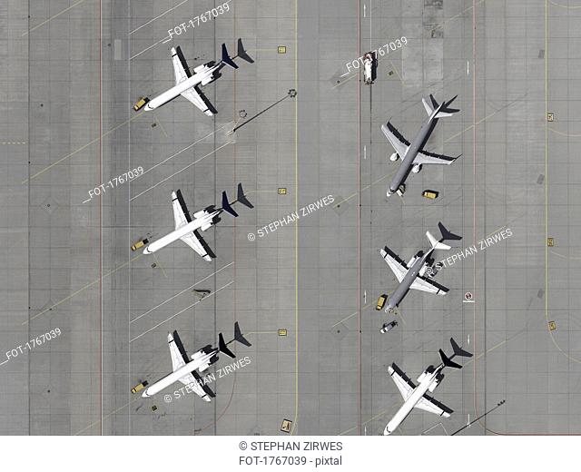 Aerial view airplanes parked on tarmac at airport