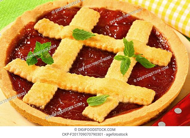 close up of strawberry jam tart with lattice on top
