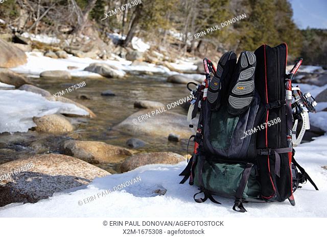 Backpack next to the East Branch of the Pemigewasset River in the Pemigewasset Wilderness of Lincoln, New Hampshire USA during the winter months