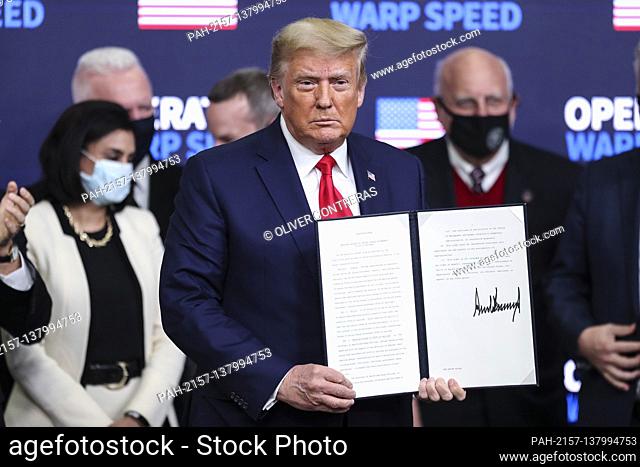 United States President Donald J. Trump stands after signing an executive order giving priority to Americans to receive American coronavirus vaccines during the...